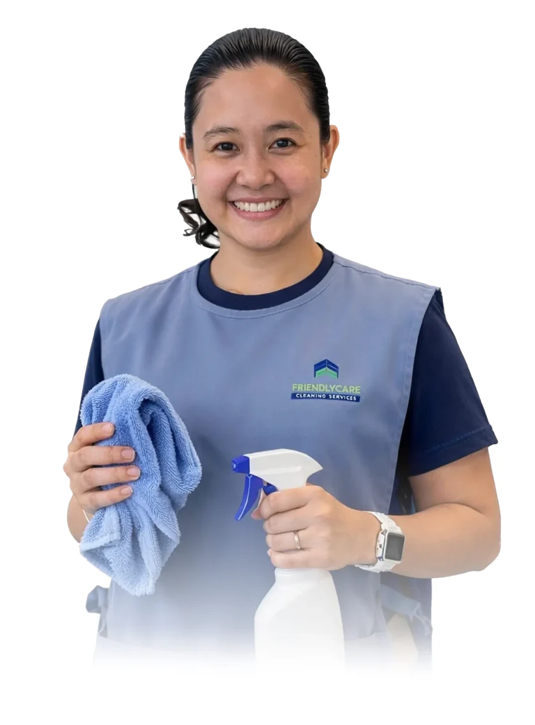 Professional cleaner holding cloth and spray bottle, representing reliable commercial cleaning services in Auckland